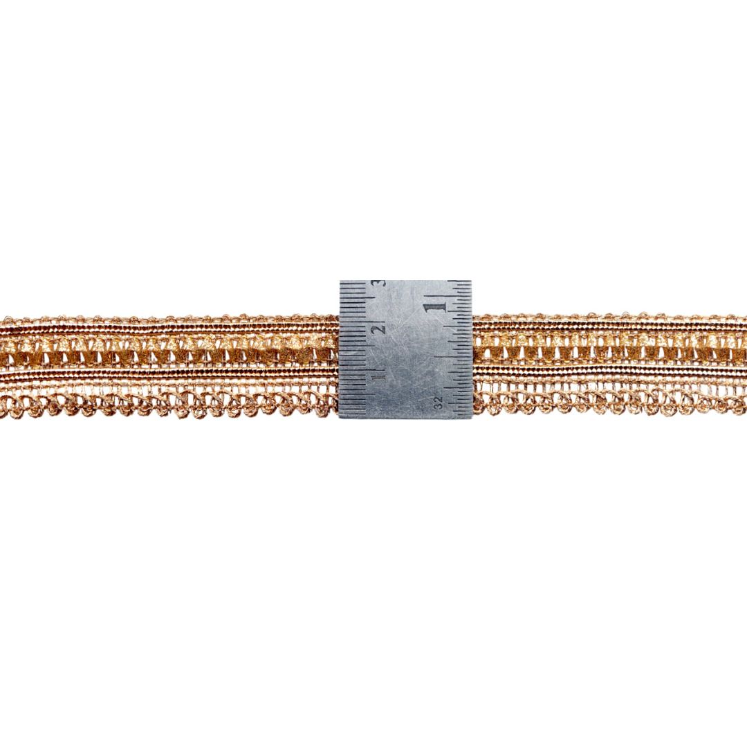 Gold chain with a ruler for scale on a white background